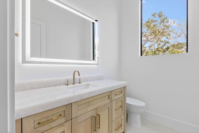 bathroom with vanity and toilet