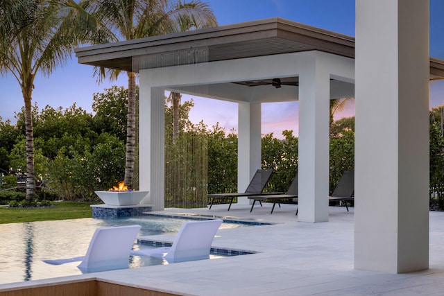 patio terrace at dusk with a gazebo and ceiling fan