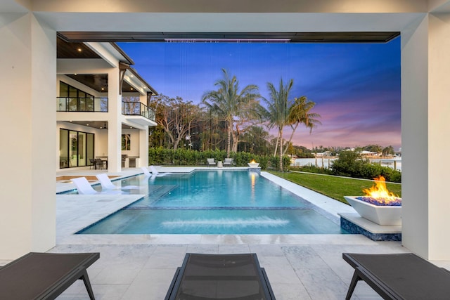 pool at dusk with a patio