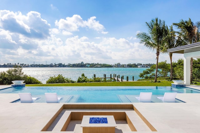 view of pool with a water view, pool water feature, an outdoor fire pit, and a patio area