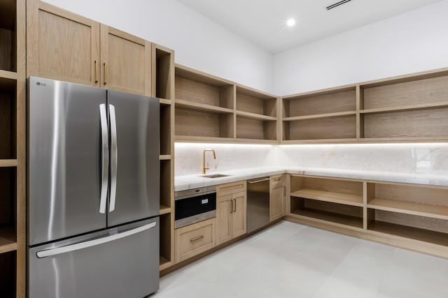 kitchen featuring sink, light brown cabinets, and appliances with stainless steel finishes