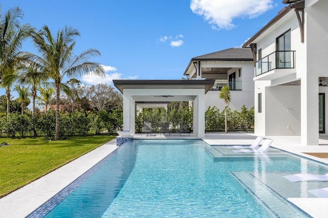 view of pool with ceiling fan, a yard, and a patio