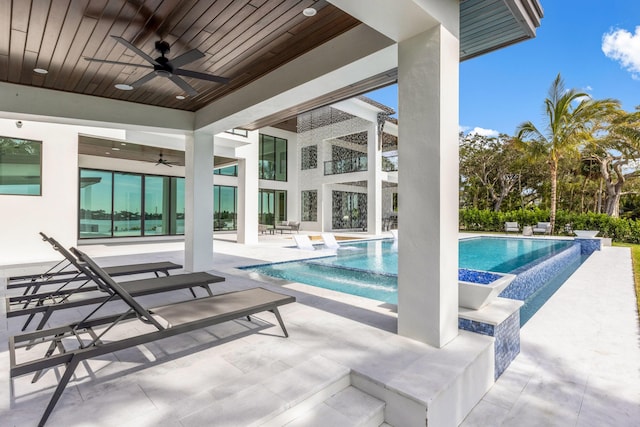 view of pool with ceiling fan and a patio area