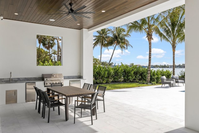 view of patio with a grill, area for grilling, sink, and ceiling fan