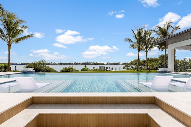 view of swimming pool featuring a water view