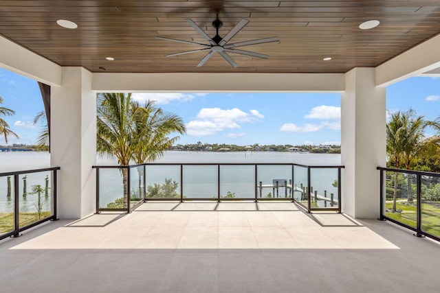 view of patio / terrace featuring a water view, ceiling fan, and a balcony