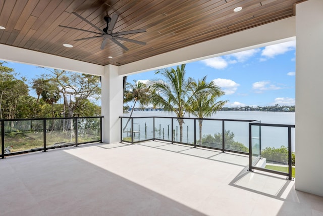 view of patio / terrace featuring a water view and ceiling fan