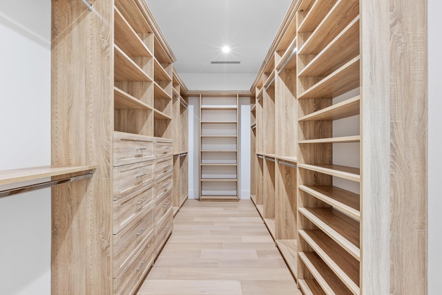 walk in closet featuring light hardwood / wood-style floors