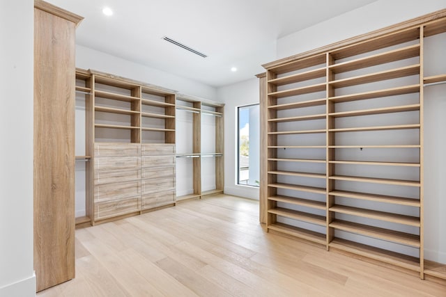 spacious closet featuring light hardwood / wood-style floors