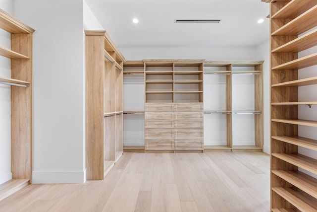 spacious closet featuring light hardwood / wood-style floors