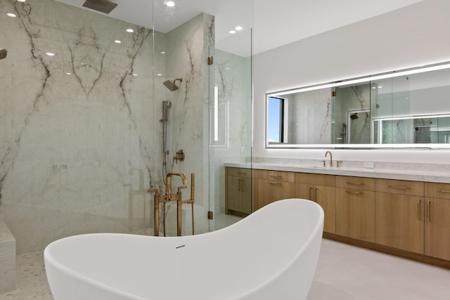 bathroom with vanity and shower with separate bathtub