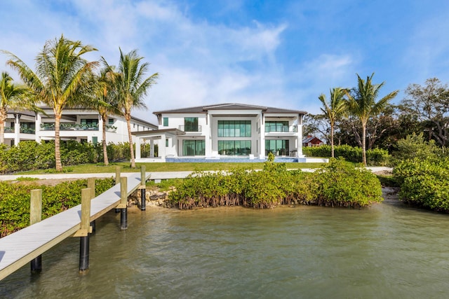 rear view of property featuring a balcony and a water view