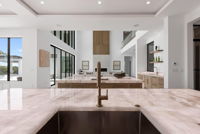 kitchen with light stone countertops and sink