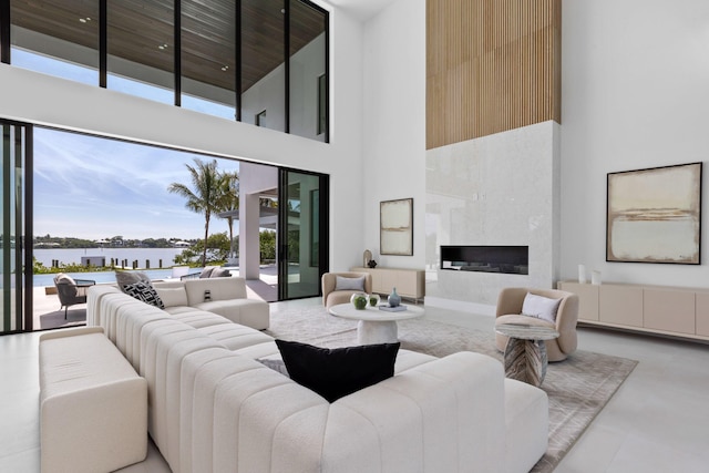 living room with a fireplace and a high ceiling