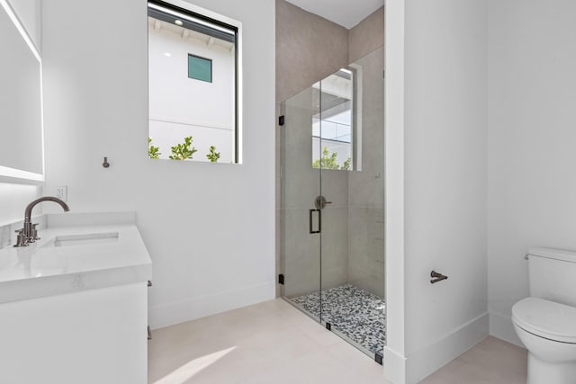 bathroom with vanity, a shower with shower door, and toilet