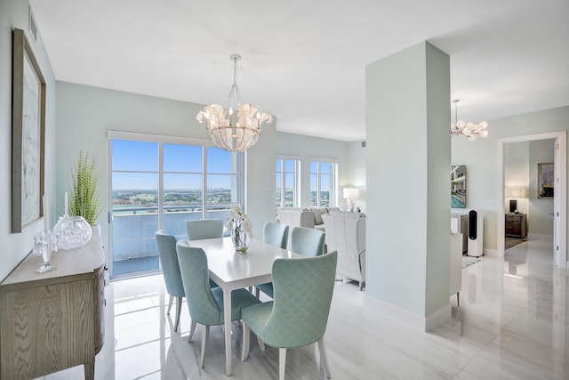 tiled dining space featuring an inviting chandelier