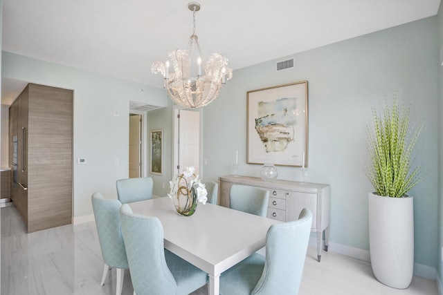 dining area with an inviting chandelier