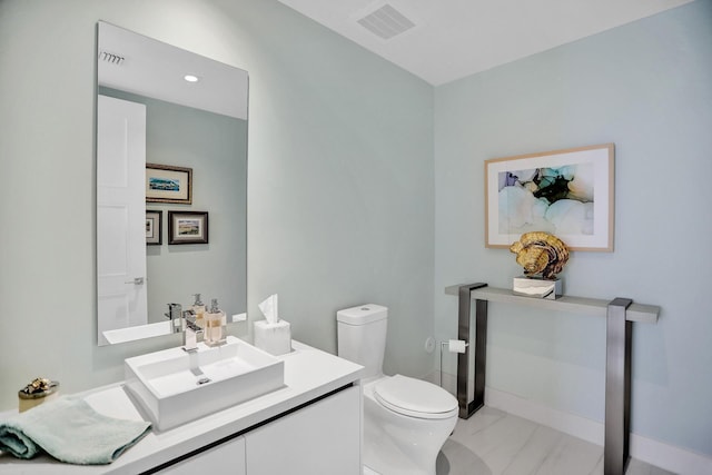 bathroom featuring vanity and toilet