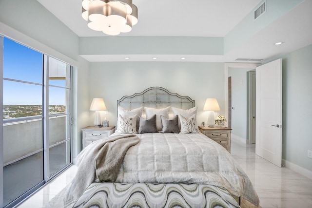 bedroom with access to outside and an inviting chandelier