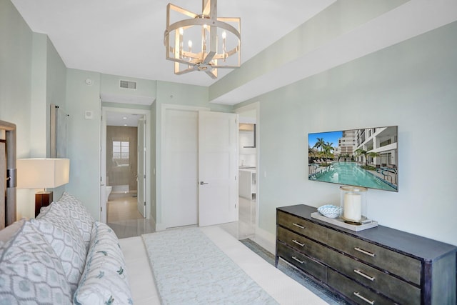 bedroom with a chandelier, light hardwood / wood-style flooring, and ensuite bath