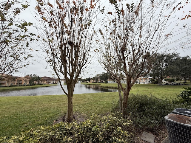 view of yard featuring a water view and central AC