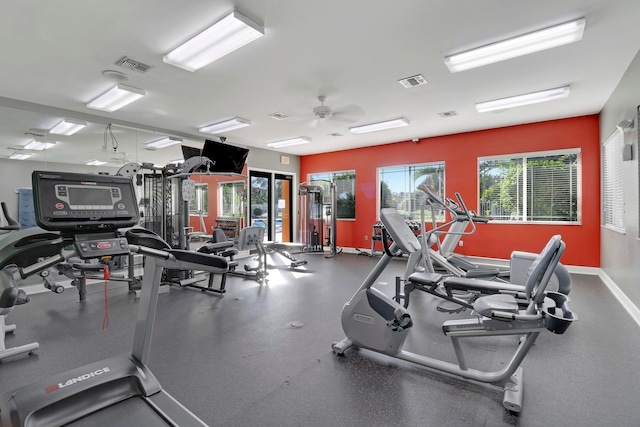 gym with ceiling fan and a healthy amount of sunlight