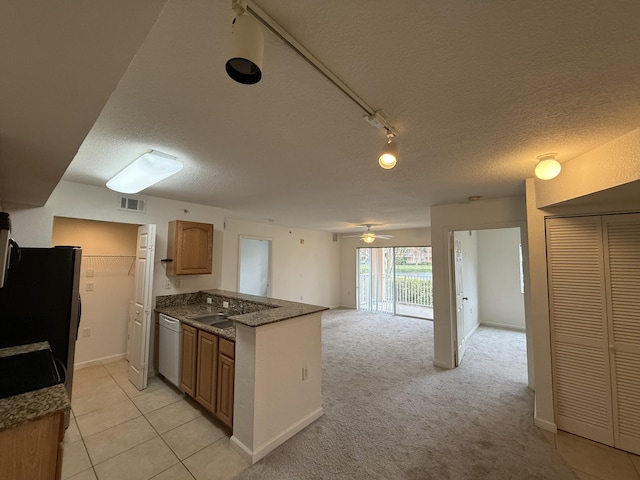 kitchen with light colored carpet, ceiling fan, sink, dishwasher, and stainless steel refrigerator