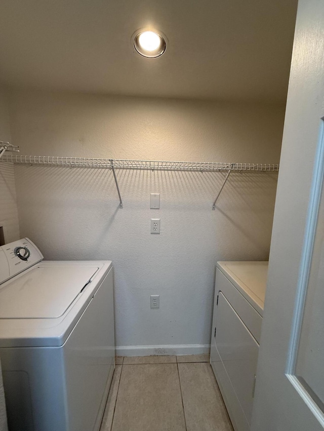 laundry area featuring light tile patterned flooring and separate washer and dryer