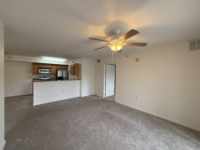 unfurnished living room featuring carpet flooring, ceiling fan, and a textured ceiling