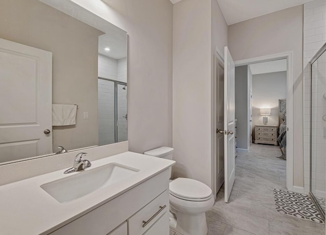 bathroom featuring vanity, toilet, and a shower with shower door