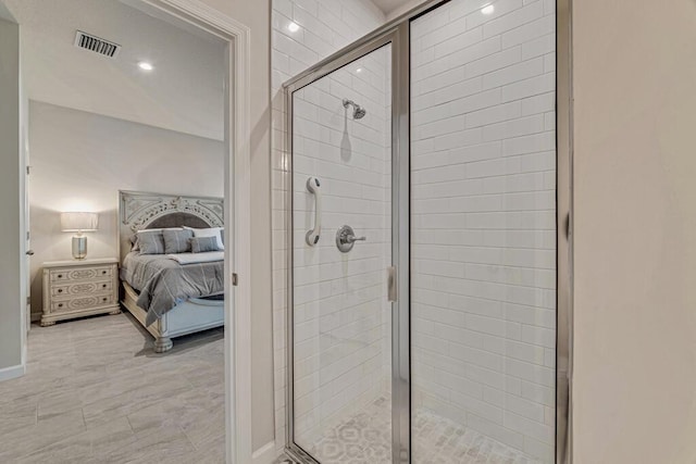 bathroom with a shower with door