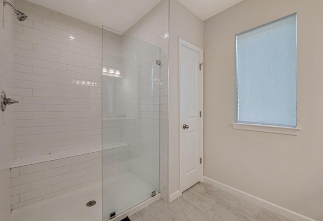 bathroom featuring tile patterned flooring and a shower with shower door