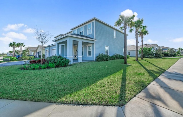 view of front of house with covered porch and a front yard