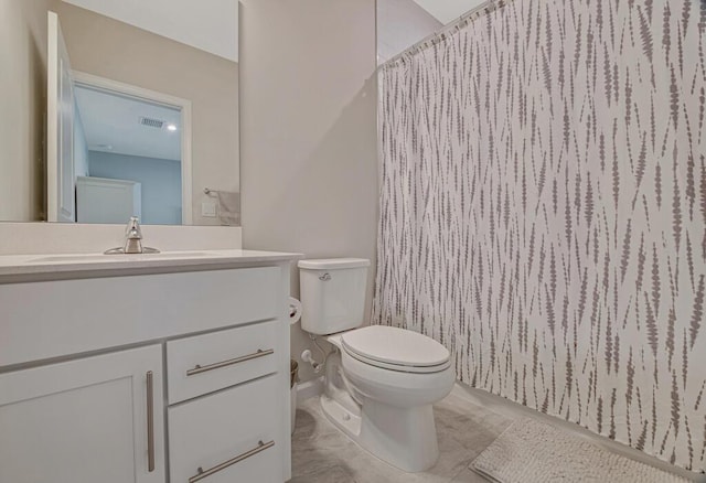 bathroom with curtained shower, tile patterned flooring, vanity, and toilet