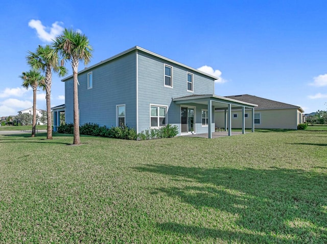 rear view of property featuring a yard and a patio