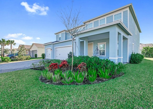 view of front of house with a garage and a front lawn