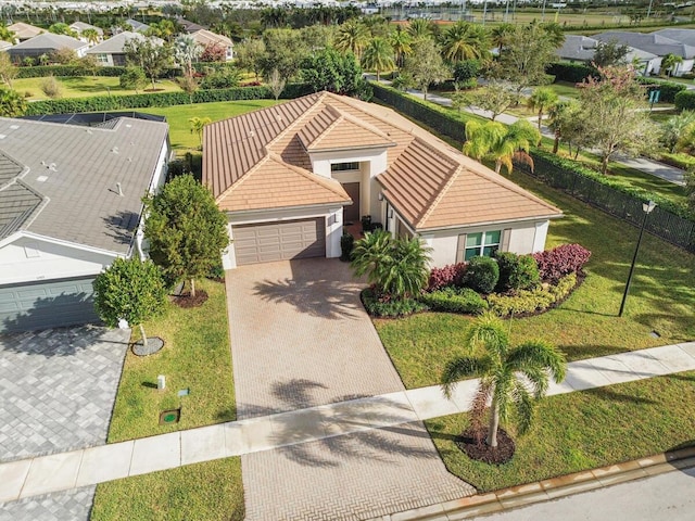 view of front of property with a garage and a front lawn