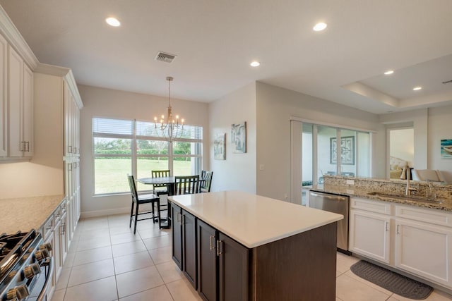 kitchen with white cabinets, sink, dark brown cabinetry, and stainless steel appliances