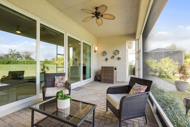 sunroom featuring ceiling fan