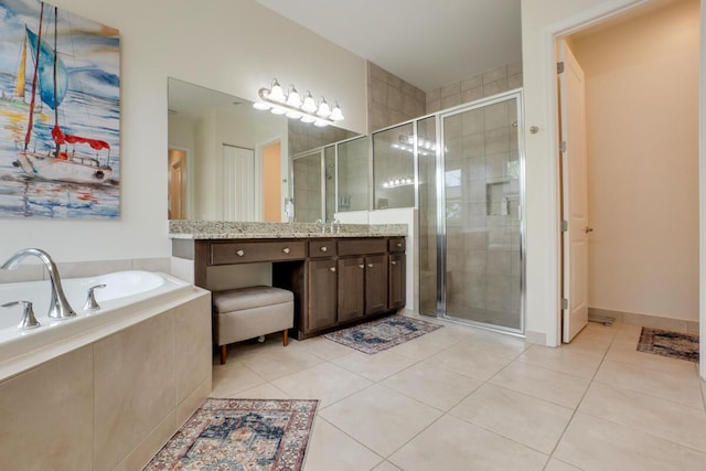 bathroom featuring tile patterned flooring, vanity, and shower with separate bathtub