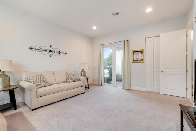 carpeted living room featuring french doors