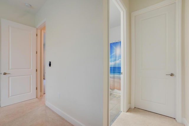 hallway featuring light carpet