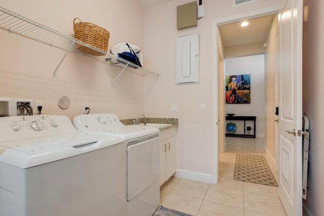 laundry room featuring cabinets, electric panel, sink, washing machine and dryer, and light tile patterned floors