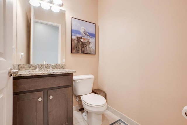 bathroom featuring tile patterned flooring, vanity, and toilet