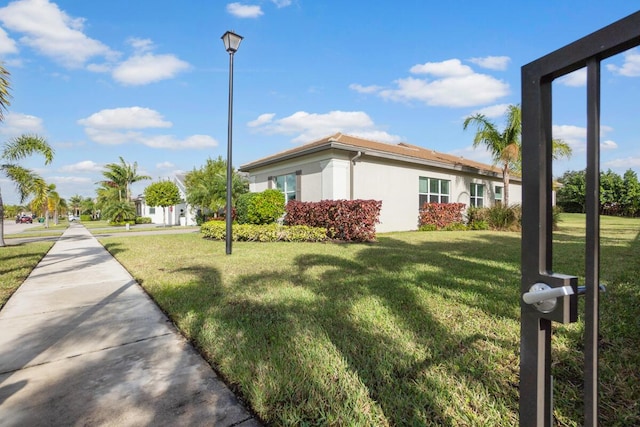 view of side of property with a lawn