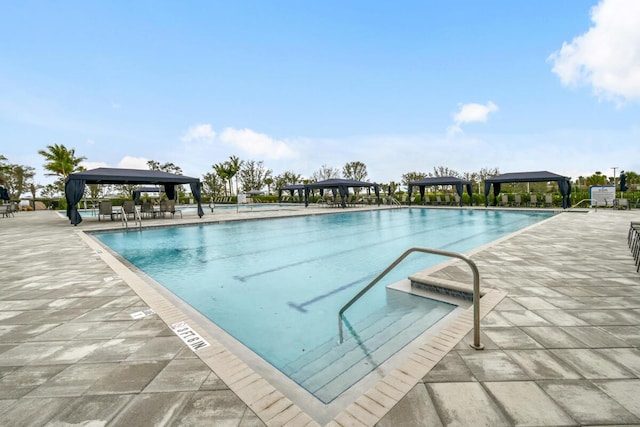 view of swimming pool featuring a gazebo and a patio area