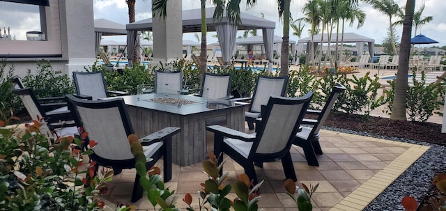 view of patio / terrace featuring a gazebo and an outdoor fire pit