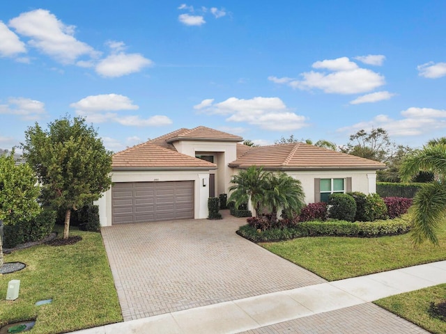 mediterranean / spanish-style home with a garage and a front yard