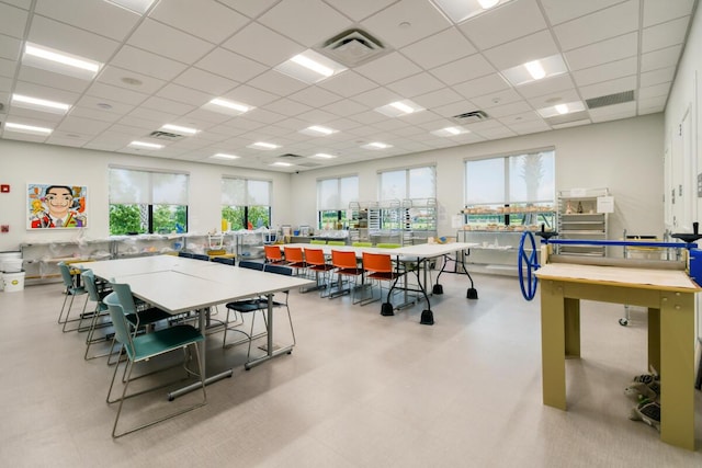 recreation room featuring plenty of natural light and a drop ceiling