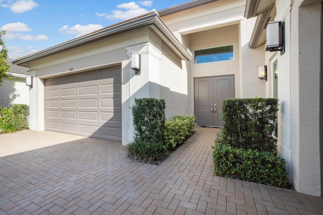 view of exterior entry featuring a garage